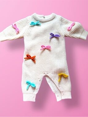 Cream Knit Baby One-Piece with Colorful Bow Accents